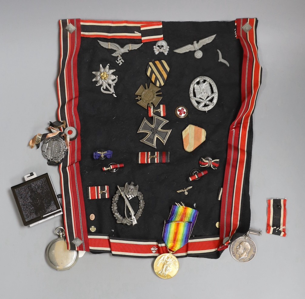 A group over WW1 to WW2 German medals and cap badges and a World War I pair to 2218924 PTE. 1. A. B. Ward. R.A.F. and two compasses